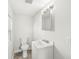 Compact white bathroom featuring modern vanity and a minimalist design at 524 S State St, Greenfield, IN 46140