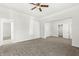 Bright bedroom featuring neutral carpet, a ceiling fan, and multiple doorways at 524 S State St, Greenfield, IN 46140