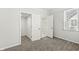 Carpeted bedroom with open closet and large window at 524 S State St, Greenfield, IN 46140