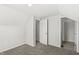 Bedroom featuring neutral carpet, freshly painted white walls, and access to a bathroom at 524 S State St, Greenfield, IN 46140
