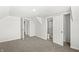Spacious bedroom featuring neutral carpet, painted white walls, and access to the bathroom at 524 S State St, Greenfield, IN 46140