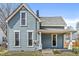 Close-up of a beautiful two-story home with blue siding and a welcoming covered front porch at 524 S State St, Greenfield, IN 46140