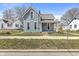 Charming two-story home featuring blue siding, a covered front porch, and well-maintained landscaping at 524 S State St, Greenfield, IN 46140