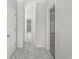 Hallway with tiled floor, white walls, and multiple doors at 524 S State St, Greenfield, IN 46140
