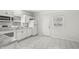 Bright and airy kitchen with white cabinets, tiled floors, and modern appliances at 524 S State St, Greenfield, IN 46140