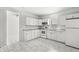 Bright and airy kitchen with white cabinets, tiled floors, and modern appliances at 524 S State St, Greenfield, IN 46140