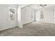 Living room featuring neutral carpet, white walls, and natural light from the windows at 524 S State St, Greenfield, IN 46140