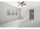 Living room featuring tiled floors, white walls, a ceiling fan, and ample natural light at 524 S State St, Greenfield, IN 46140