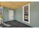 View of a cozy porch with door, window, and a carpeted floor at 524 S State St, Greenfield, IN 46140