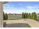 Outdoor patio area overlooking backyard, pond, and neighboring houses at 5806 Belvista Dr, Plainfield, IN 46168