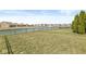 A wide view of backyard featuring lawn and the pond with neighborhood homes in background at 5806 Belvista Dr, Plainfield, IN 46168