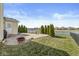 Backyard patio with fire pit, landscaping and a view of the pond at 5806 Belvista Dr, Plainfield, IN 46168