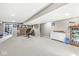 View of finished basement showing carpeted area, shelves, workout equipment, and stairway at 5806 Belvista Dr, Plainfield, IN 46168