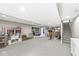 Spacious finished basement with carpet, storage shelves, and workout area at 5806 Belvista Dr, Plainfield, IN 46168