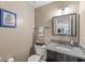 Well-maintained half-bathroom features a granite countertop vanity, classic fixtures, and neutral wall color at 5806 Belvista Dr, Plainfield, IN 46168
