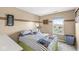 Bedroom with tan walls, carpet, and a window with a view of the backyard at 5806 Belvista Dr, Plainfield, IN 46168