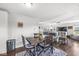 Cozy dining area features a rustic wooden table, stylish chairs, and an open view to the adjacent living space at 5806 Belvista Dr, Plainfield, IN 46168