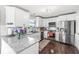 Bright kitchen with white cabinetry, granite countertops, stainless steel appliances, and subway tile backsplash at 5806 Belvista Dr, Plainfield, IN 46168