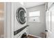 Practical laundry room featuring a stacked washer and dryer unit, counter space, and natural light from a window at 5806 Belvista Dr, Plainfield, IN 46168