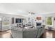 Bright living room featuring a fireplace, large windows, and a plush sectional sofa at 5806 Belvista Dr, Plainfield, IN 46168