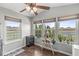 Bright sunroom with multiple windows offering scenic views of the surrounding landscape and a tranquil pond at 5806 Belvista Dr, Plainfield, IN 46168