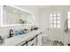 Bathroom featuring double sinks, a modern mirror, and sleek fixtures at 6034 Guilford Ave, Indianapolis, IN 46220