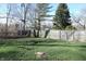 Well-maintained backyard with a wood fence and mature trees, providing privacy at 6041 Dewey Ave, Indianapolis, IN 46219