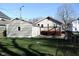 Home featuring a wooden deck, a detached garage, and a view of the backyard at 6041 Dewey Ave, Indianapolis, IN 46219