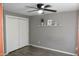 Neutral bedroom featuring a ceiling fan, closet with paneled doors, and a shelf for decorations at 6041 Dewey Ave, Indianapolis, IN 46219