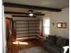 Living room featuring exposed beams, built-in shelving and hardwood floors with neutral decor at 6041 Dewey Ave, Indianapolis, IN 46219