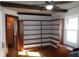 Inviting living room showcasing built-in shelving, wood floors, large window, and exposed beams at 6041 Dewey Ave, Indianapolis, IN 46219