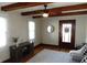 Bright living room featuring hardwood floors, beamed ceiling, and natural light at 6041 Dewey Ave, Indianapolis, IN 46219