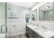 Modern bathroom features a double vanity with a marble countertop and subway tile shower at 671 Spring Hills Dr, Zionsville, IN 46077