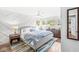 Serene bedroom featuring accent wall, hardwood floors, and multiple windows at 671 Spring Hills Dr, Zionsville, IN 46077
