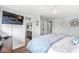 Bright bedroom with hardwood floors, a television, and a glimpse of an ensuite bathroom at 671 Spring Hills Dr, Zionsville, IN 46077