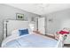Light-filled bedroom with hardwood floors, a white wood bed, and a ceiling fan at 671 Spring Hills Dr, Zionsville, IN 46077