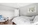 Bright bedroom featuring hardwood floors, a ceiling fan, and neutral paint at 671 Spring Hills Dr, Zionsville, IN 46077