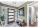 Entryway with modern door, decorative bench, and artwork creating a welcoming atmosphere at 671 Spring Hills Dr, Zionsville, IN 46077