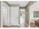 Bright hallway with tile flooring, white doors, and views leading to the backyard patio at 671 Spring Hills Dr, Zionsville, IN 46077