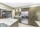 Updated kitchen with stainless steel refrigerator, marble countertops, and custom cabinets at 671 Spring Hills Dr, Zionsville, IN 46077