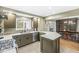 Bright, open kitchen featuring stainless steel appliances, an island, and seamless flow to dining and living areas at 671 Spring Hills Dr, Zionsville, IN 46077