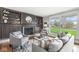 Inviting living room featuring built-in shelving, a cozy fireplace, and large windows overlooking the lawn at 671 Spring Hills Dr, Zionsville, IN 46077
