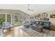 Sunlit living room featuring a vaulted ceiling, French doors, and a comfortable seating area at 671 Spring Hills Dr, Zionsville, IN 46077