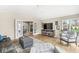 Spacious living room with hardwood floors, TV and backyard views and access to a seating area and backyard at 671 Spring Hills Dr, Zionsville, IN 46077