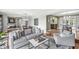 Open-concept living room with hardwood floors, a comfortable sofa, and access to the dining and kitchen areas at 671 Spring Hills Dr, Zionsville, IN 46077