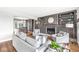Cozy living room with a fireplace, custom shelving, and comfortable seating arrangements at 671 Spring Hills Dr, Zionsville, IN 46077