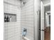 Updated shower with white subway tile, decorative niche, and modern fixtures at 671 Spring Hills Dr, Zionsville, IN 46077