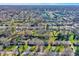 Wide aerial view showcasing a neighborhood with a mix of single-Gathering homes, trees, and green spaces at 7133 Mc Lain Dr, Indianapolis, IN 46217