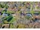 Aerial view of a neighborhood with neat homes and well-manicured lawns amidst mature trees at 7133 Mc Lain Dr, Indianapolis, IN 46217