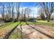 Large backyard featuring a shed, fenced perimeter, and a concrete patio area, ideal for outdoor activities at 7133 Mc Lain Dr, Indianapolis, IN 46217